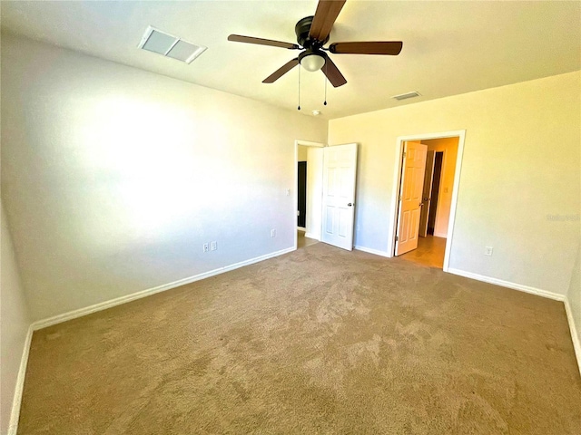 empty room featuring ceiling fan and carpet