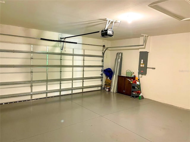 garage with a garage door opener and electric panel