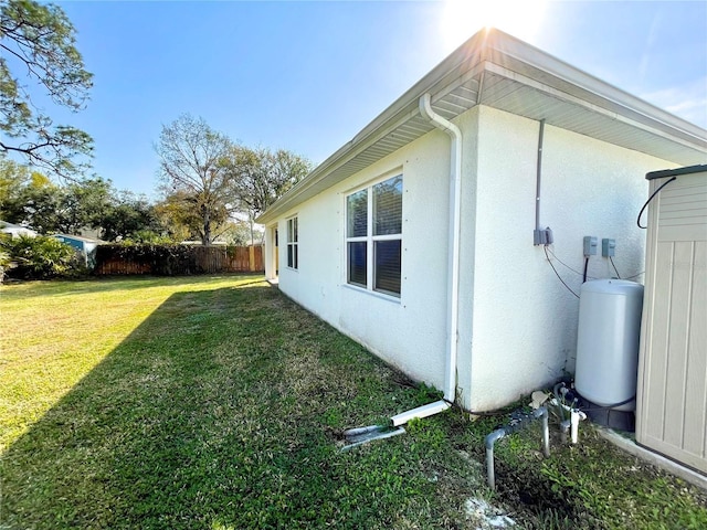 view of property exterior with a yard