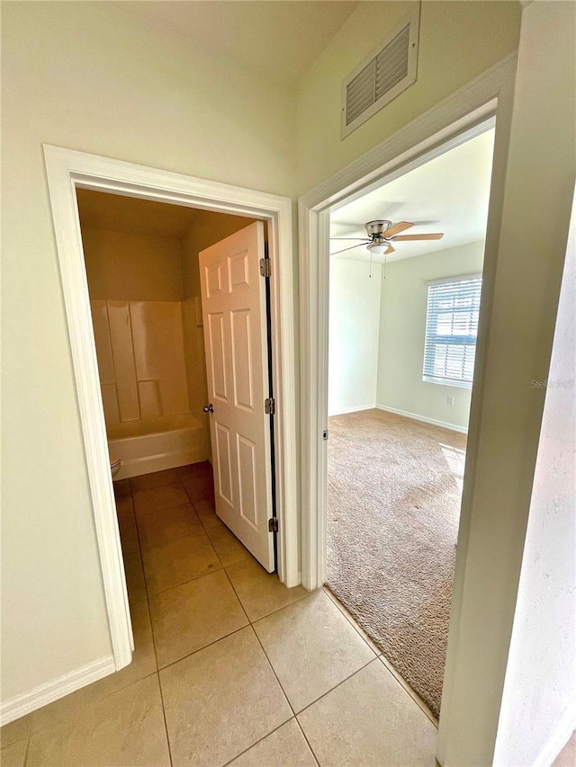 corridor with light colored carpet