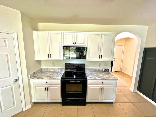 kitchen featuring white cabinetry, black appliances, and light tile patterned flooring