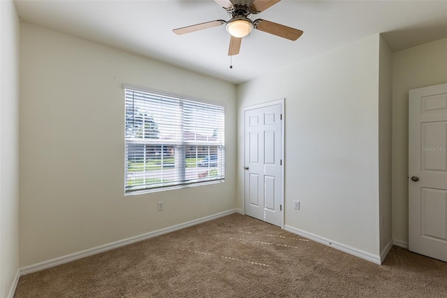 unfurnished bedroom with ceiling fan, carpet floors, and a closet