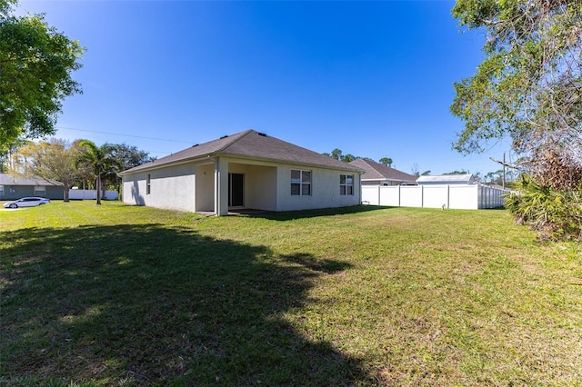 back of property featuring a yard