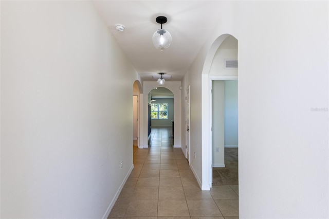 corridor featuring light tile patterned floors