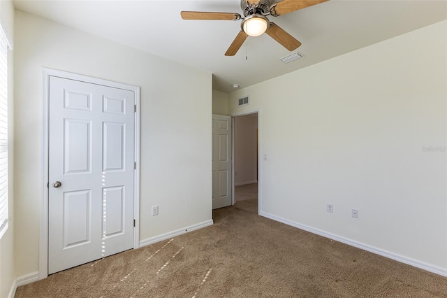 unfurnished bedroom featuring ceiling fan and carpet