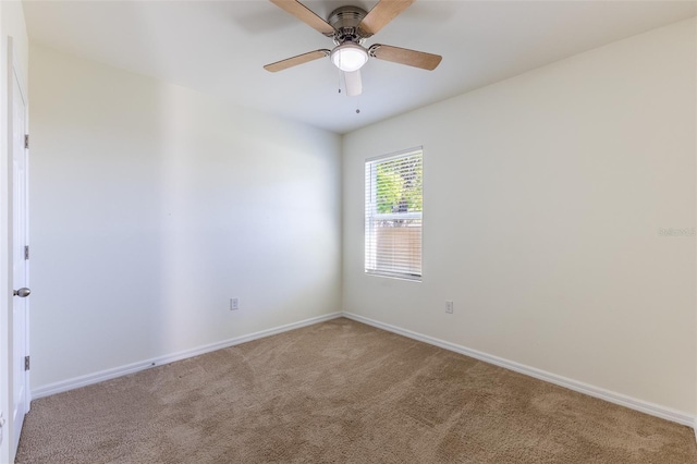 empty room featuring carpet floors and ceiling fan