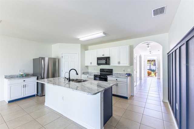 kitchen featuring a center island with sink, white cabinetry, sink, and black appliances