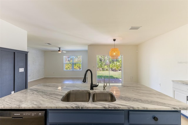 kitchen with sink, blue cabinetry, dishwasher, hanging light fixtures, and light stone countertops