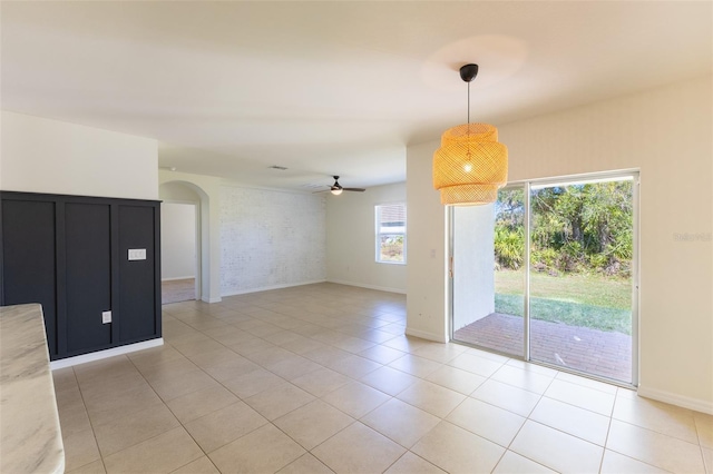 tiled spare room with ceiling fan