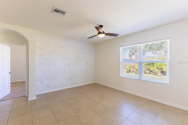 tiled empty room with ceiling fan