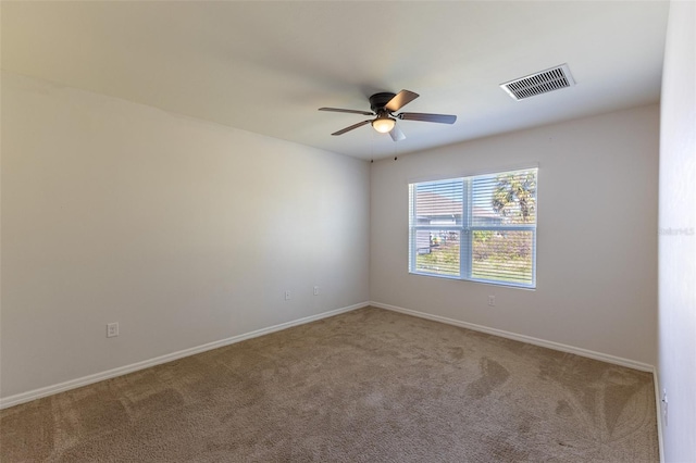 empty room featuring ceiling fan and carpet floors