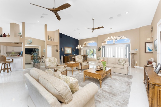 tiled living room featuring ceiling fan with notable chandelier and high vaulted ceiling