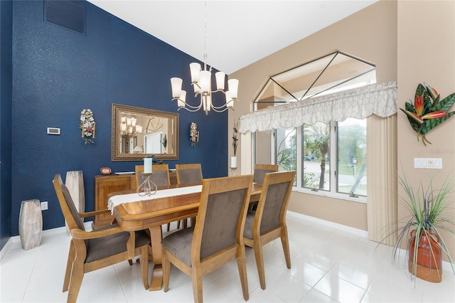 tiled dining area featuring a chandelier