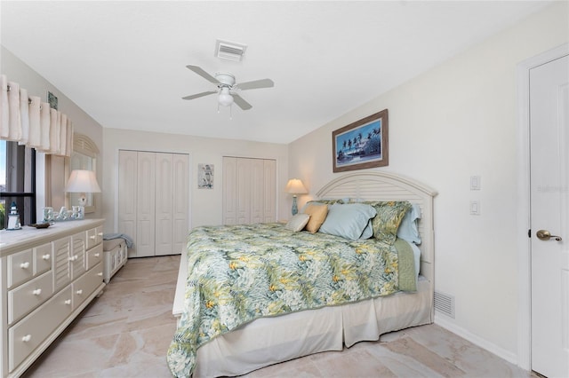 bedroom featuring multiple closets and ceiling fan