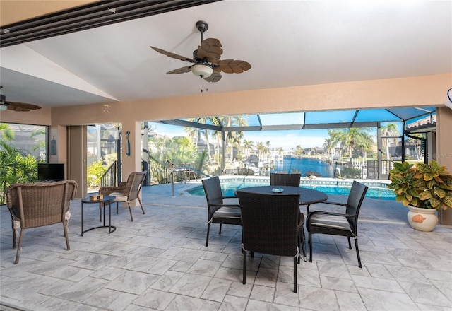 view of patio / terrace featuring ceiling fan and glass enclosure