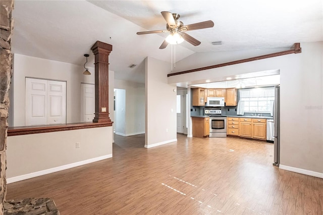 kitchen featuring ceiling fan, hardwood / wood-style floors, stainless steel appliances, vaulted ceiling, and ornate columns