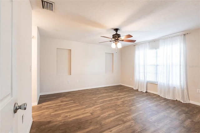 empty room with dark wood-type flooring and ceiling fan