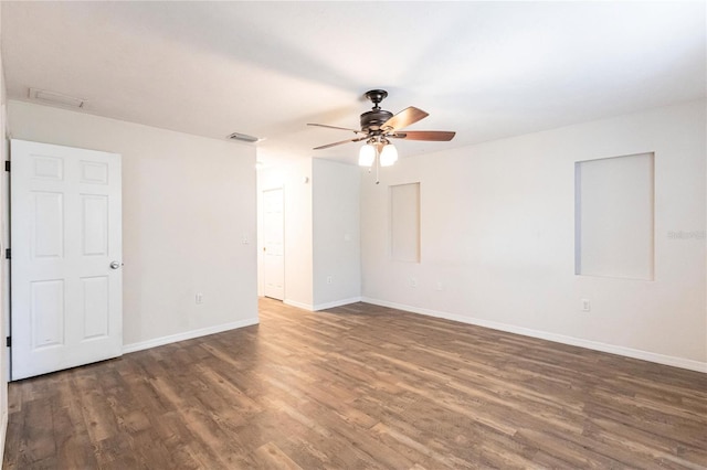 unfurnished room featuring ceiling fan and dark hardwood / wood-style flooring