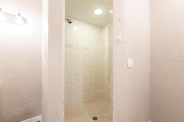 bathroom with tiled shower