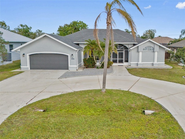 view of front facade with a garage and a front lawn