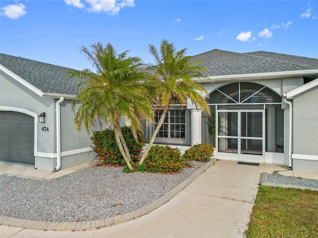 doorway to property with a garage