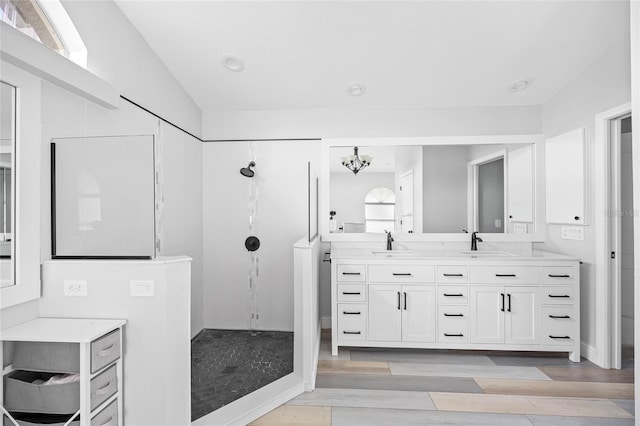 bathroom featuring walk in shower, vanity, a chandelier, and hardwood / wood-style flooring