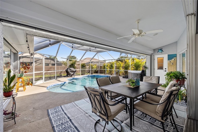 view of swimming pool featuring a hot tub, a patio, and glass enclosure