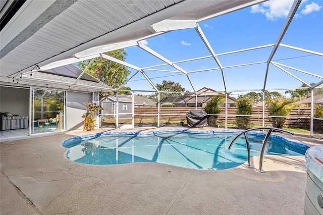 view of swimming pool featuring a storage shed, a lanai, and a patio area