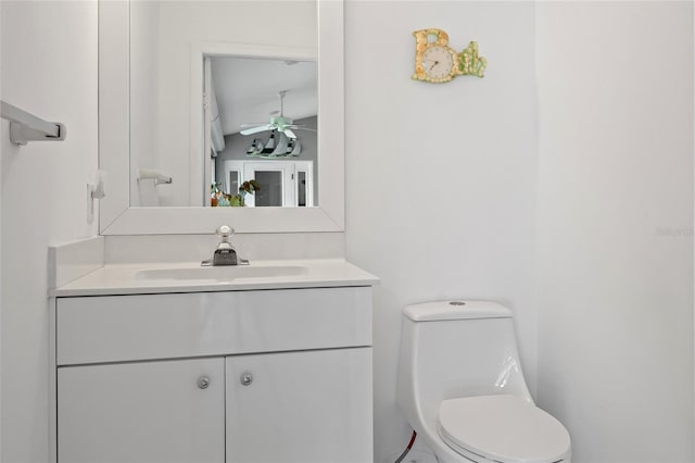 bathroom featuring vanity, ceiling fan, and toilet