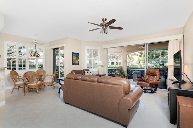 living room featuring light tile patterned floors and ceiling fan