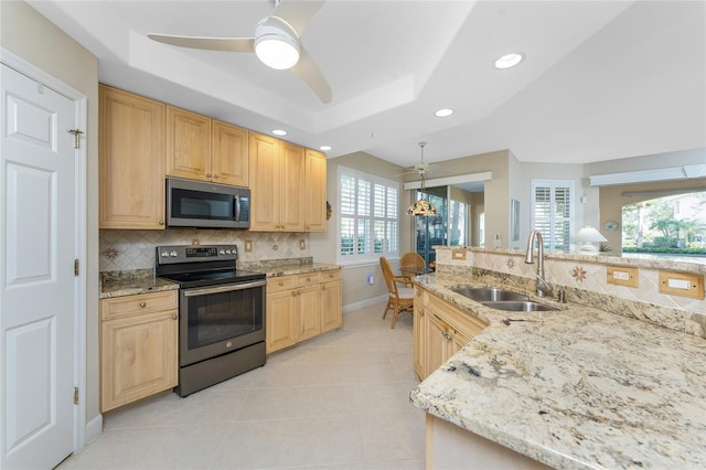 kitchen with sink, stainless steel appliances, a raised ceiling, and light brown cabinets