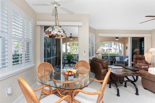 dining space featuring light tile patterned flooring and ceiling fan