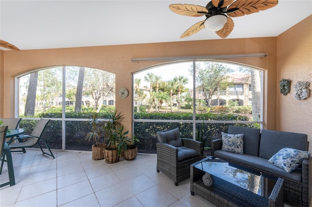 sunroom / solarium featuring ceiling fan