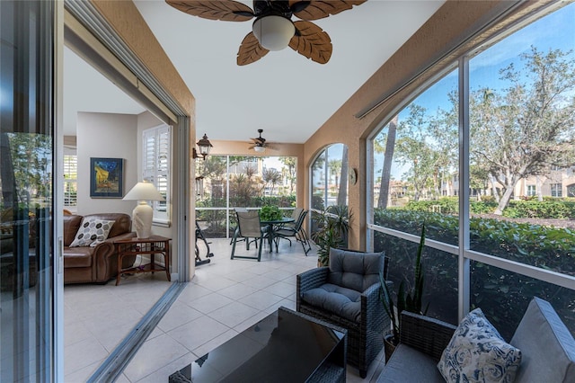 sunroom featuring ceiling fan and vaulted ceiling