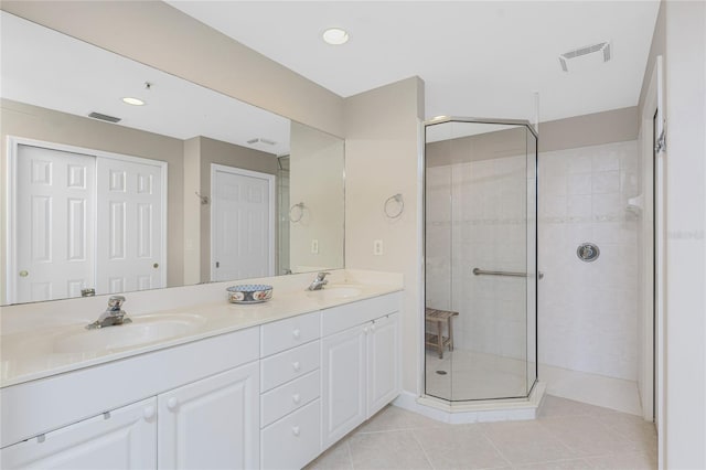 bathroom with tile patterned floors, vanity, and an enclosed shower