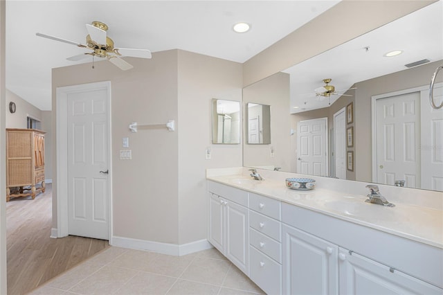 bathroom with tile patterned flooring, vanity, and ceiling fan