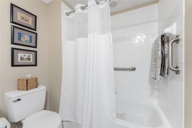 bathroom featuring shower / bath combo and toilet