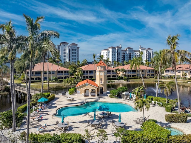 view of pool featuring a patio area and a water view