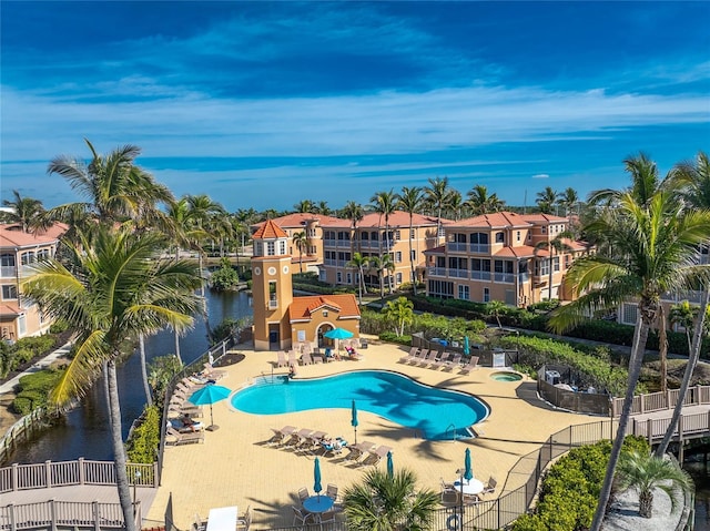 view of swimming pool featuring a water view and a patio area