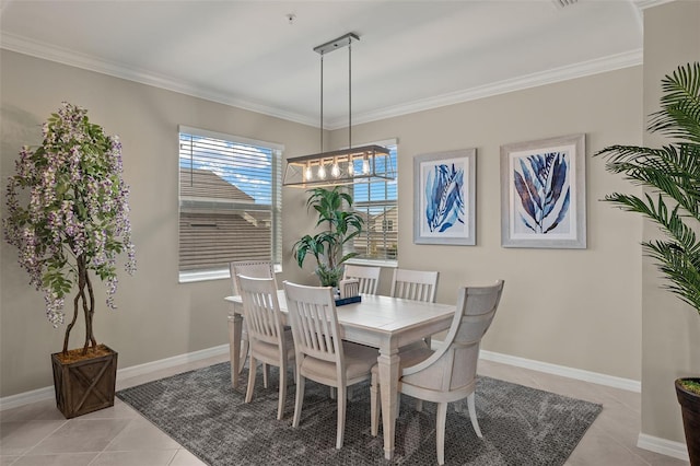 dining space with ornamental molding and light tile patterned floors