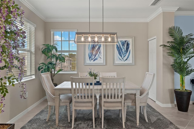 dining area with light tile patterned floors and crown molding