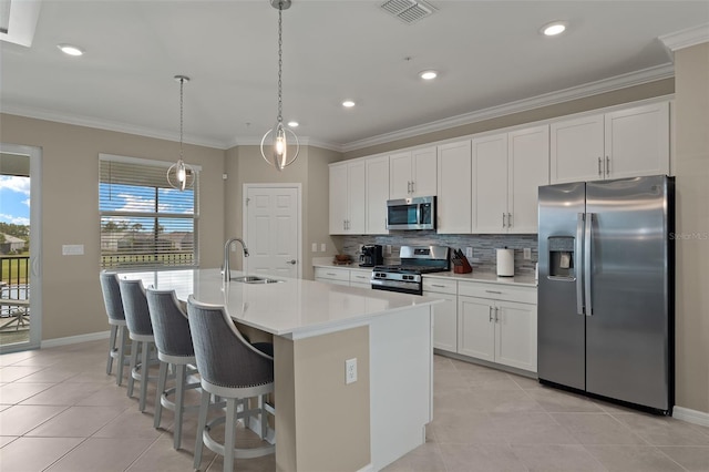 kitchen with sink, stainless steel appliances, an island with sink, and white cabinets