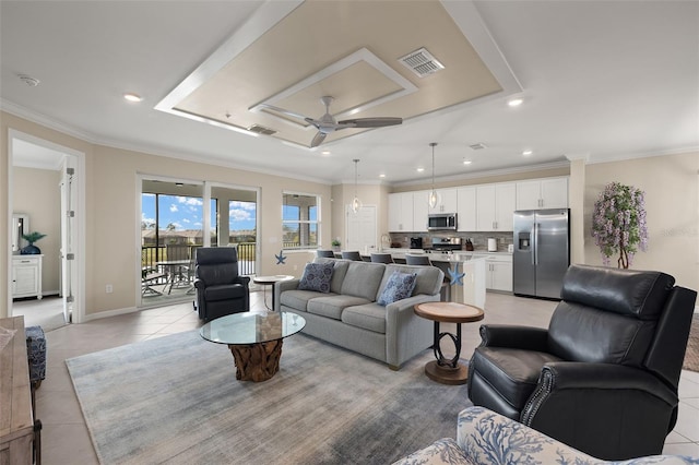 tiled living room with crown molding and ceiling fan