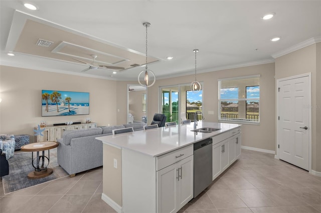 kitchen with sink, stainless steel dishwasher, pendant lighting, a kitchen island with sink, and white cabinets