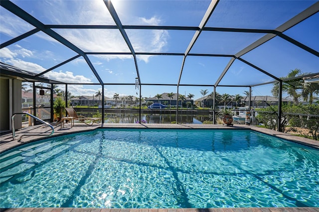 view of swimming pool with a water view and a lanai