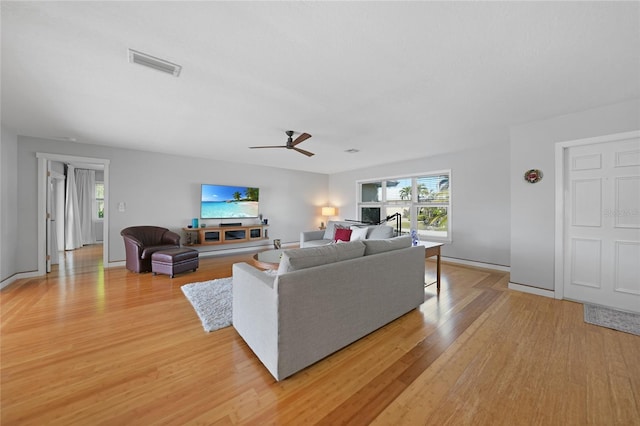 living room with ceiling fan and light wood-type flooring