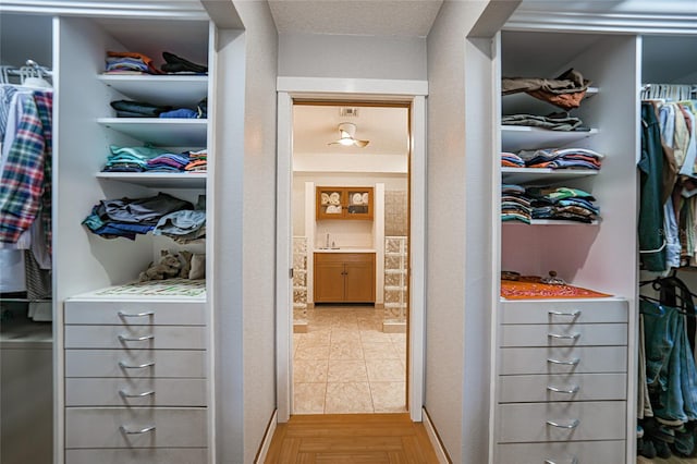 walk in closet with light wood-type flooring