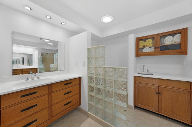 bathroom featuring walk in shower, tile patterned floors, and vanity