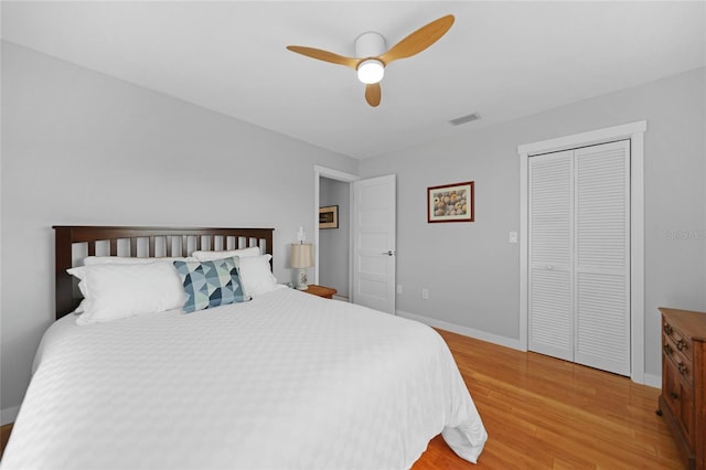 bedroom featuring hardwood / wood-style flooring, ceiling fan, and a closet