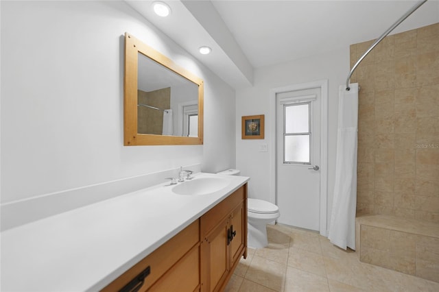 bathroom featuring vanity, tile patterned floors, toilet, and walk in shower